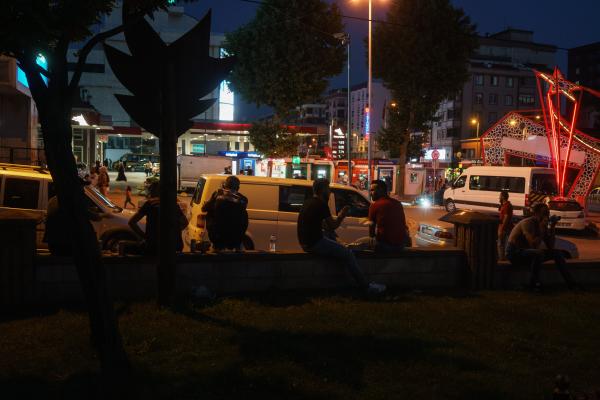 Stuck: The plight of Turkey's Afghan migrants - A group of immigrants in Sultangazi 15 Temmuz Park at evening. Sultangazi, Istanbul 2021