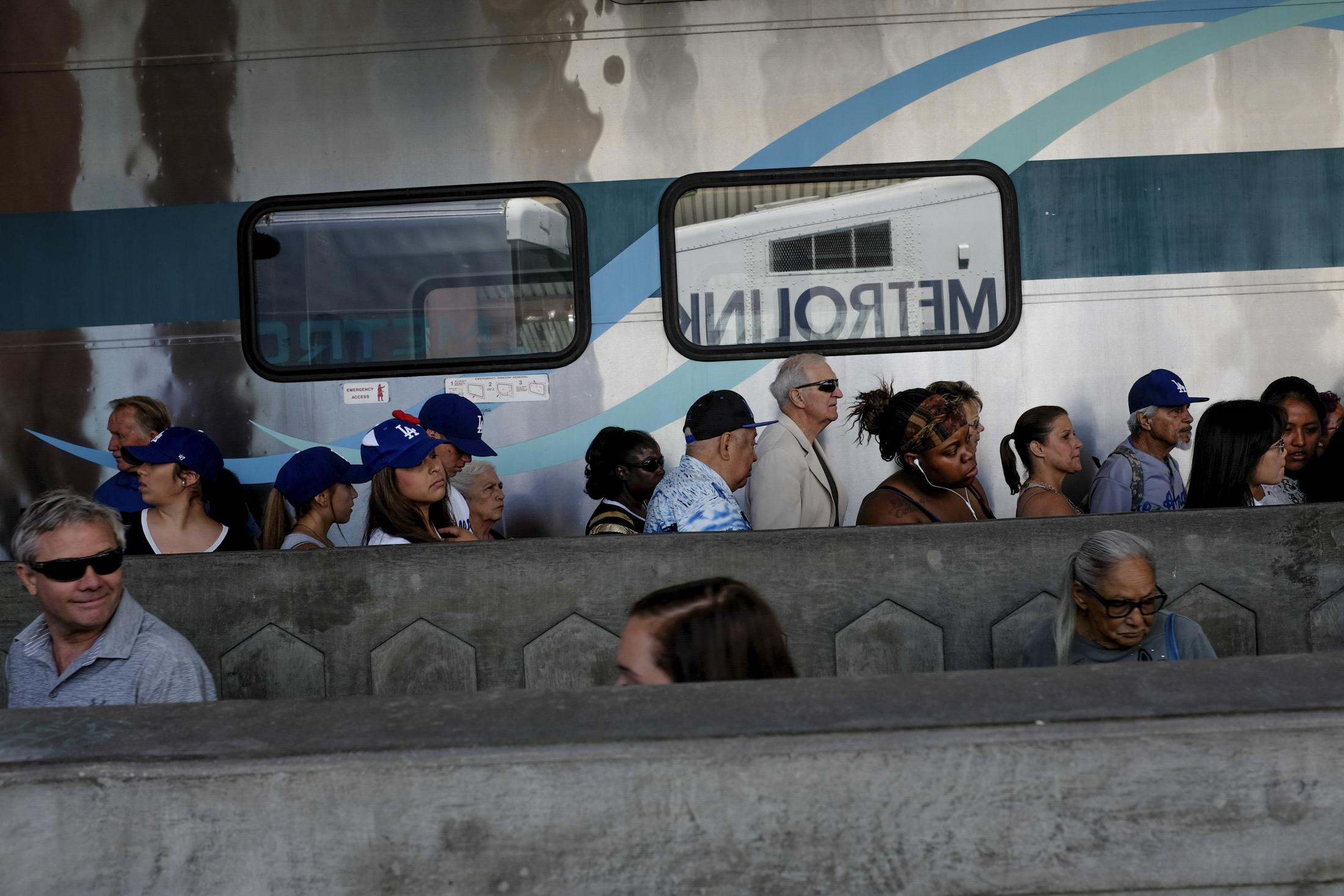 Travelers walk off the Metrolink in Los Angeles, California.