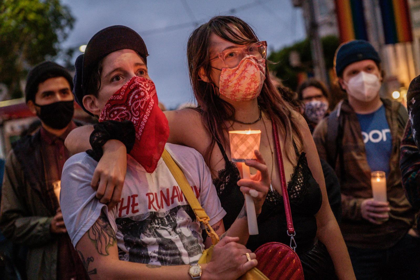 Image from NEWS - Noelle Skool, left, and Alex Sophinos attend a vigil for...