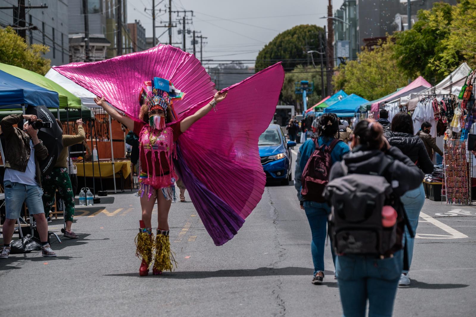 A visitor photographs Juan Davila as Carnaval celebrations kicked off in San Francisco on Saturday, May 29, 2021. For the second year, CANA-Carnaval San Francisco will hold a community resource fair in place of its traditional parade and festival. The event will celebrate the resilience of those who have been disproportionately affected by the pandemic and provide numerous health and economic equity resources.