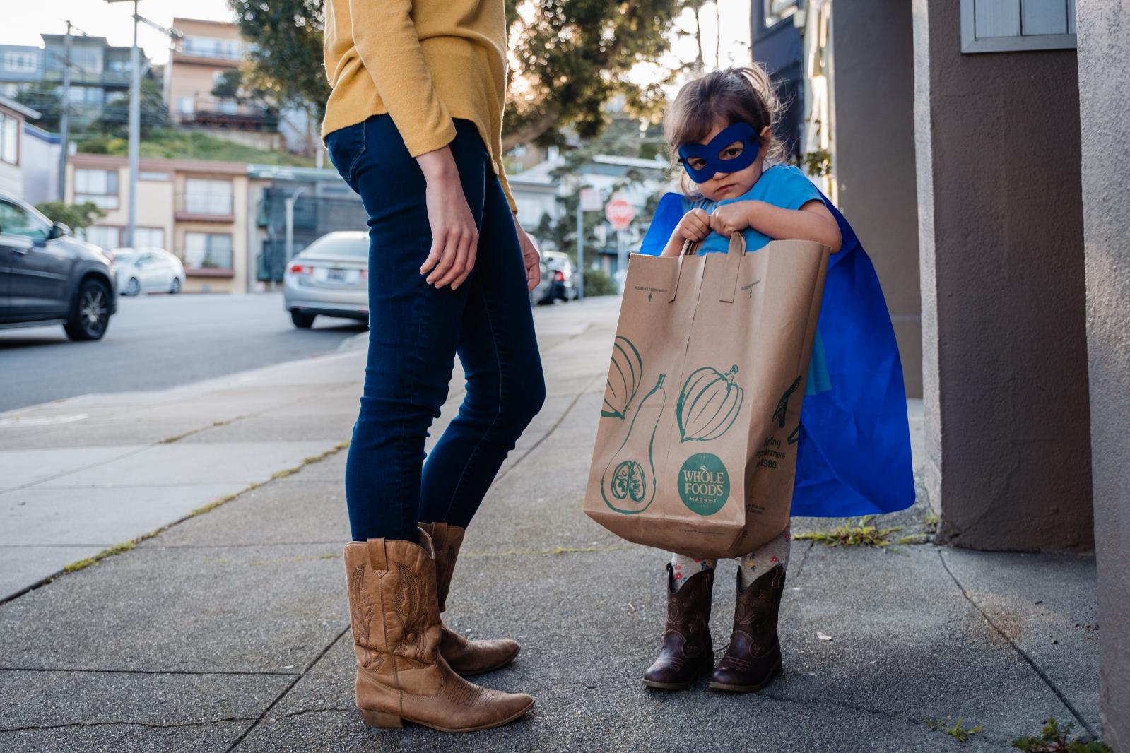Jamiee Roesch and her daughter Finley deliver bags of donated masks, and gloves to a health care professional in San Francisco, Calif. on Thursday,