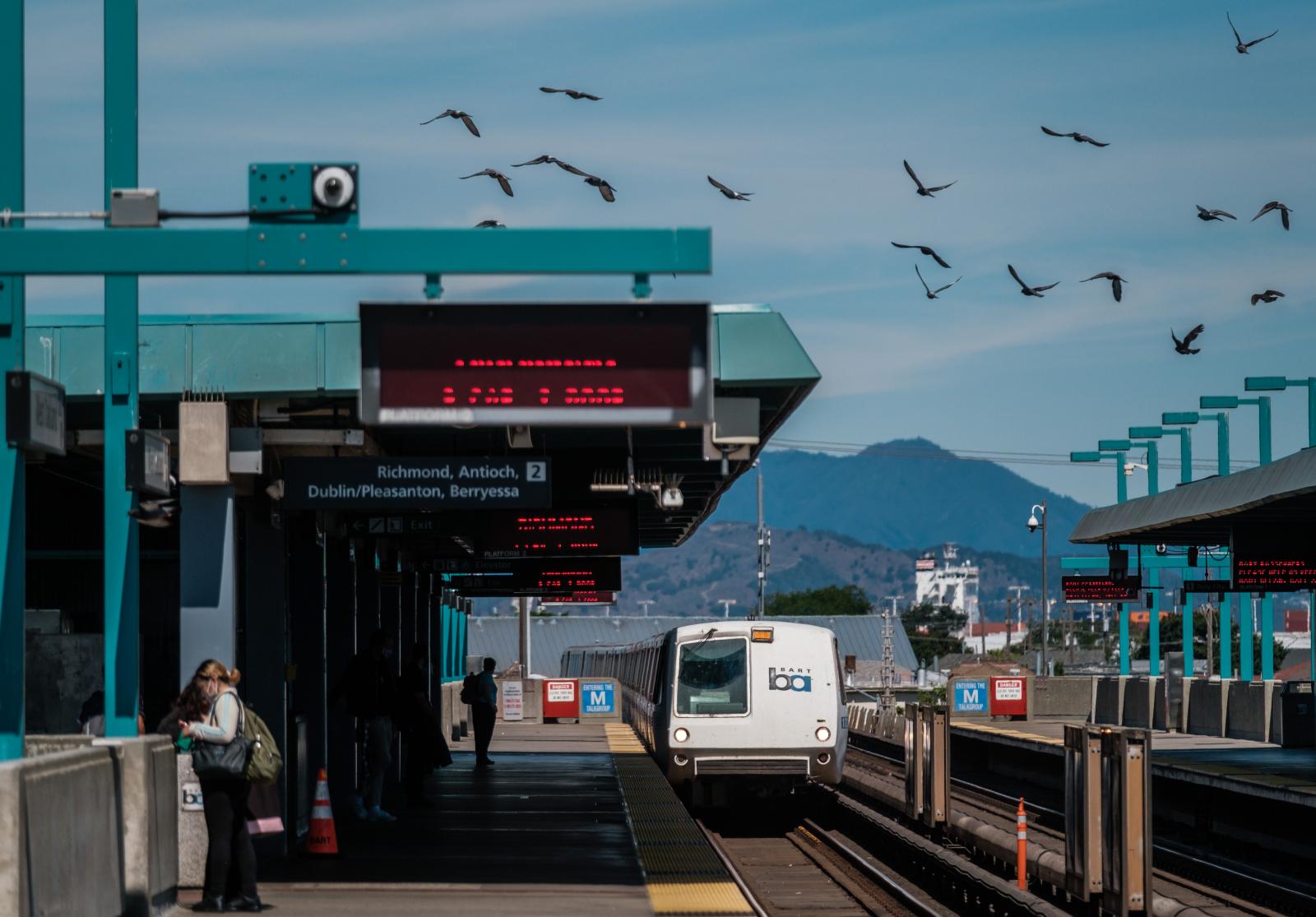 Riders are seen waiting for trains at the West Oakland BART Station in Oakland on Monday, August 2, 2021. BART is restoring services to near pre-pandemic levels starting Monday. Trains will once again run every 15 minutes. Hours of operation will extend to midnight.