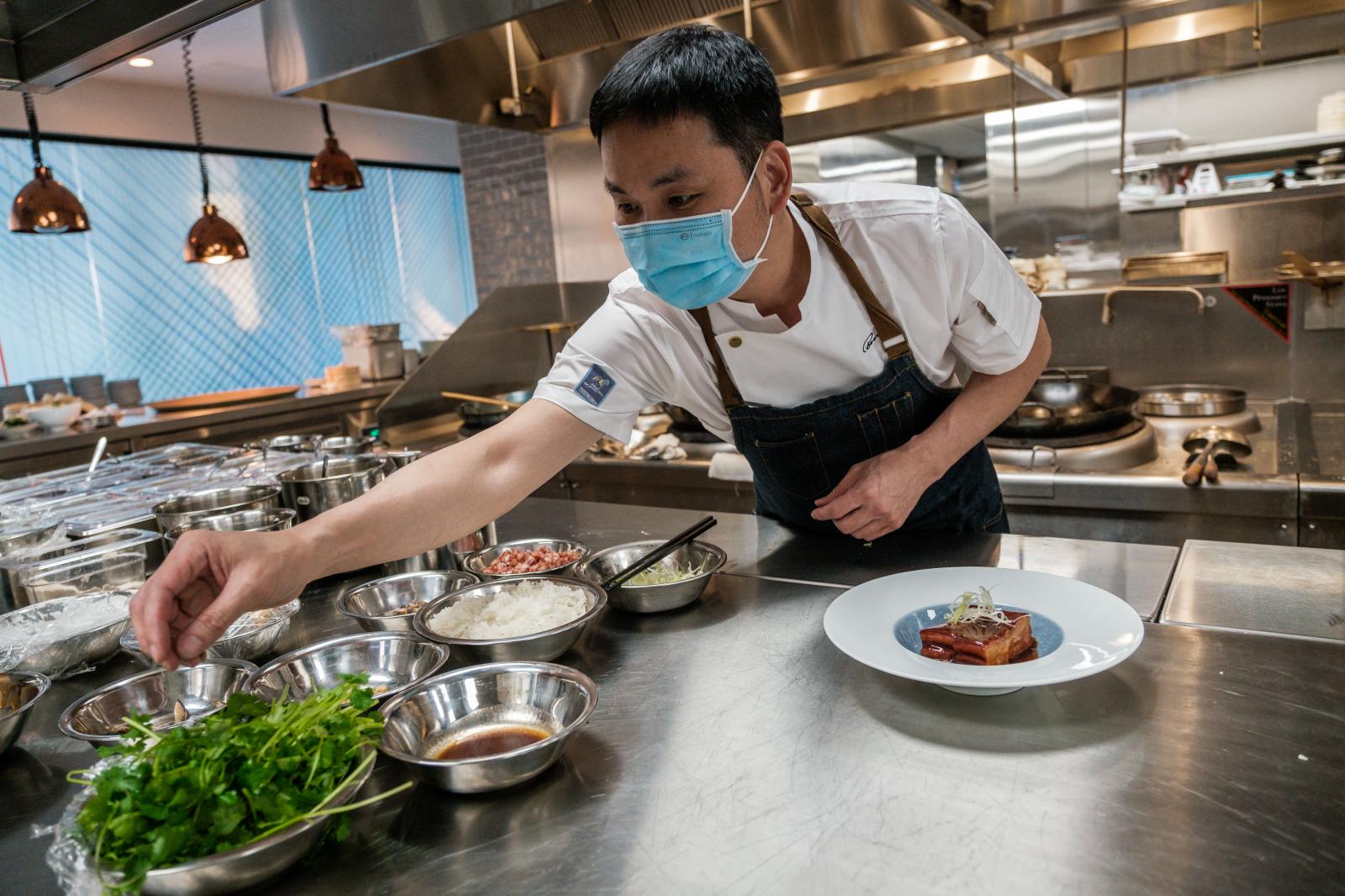 Image from FOOD/DRINK - Chef Ho Chee Boon puts the finishing touches on a dish at...