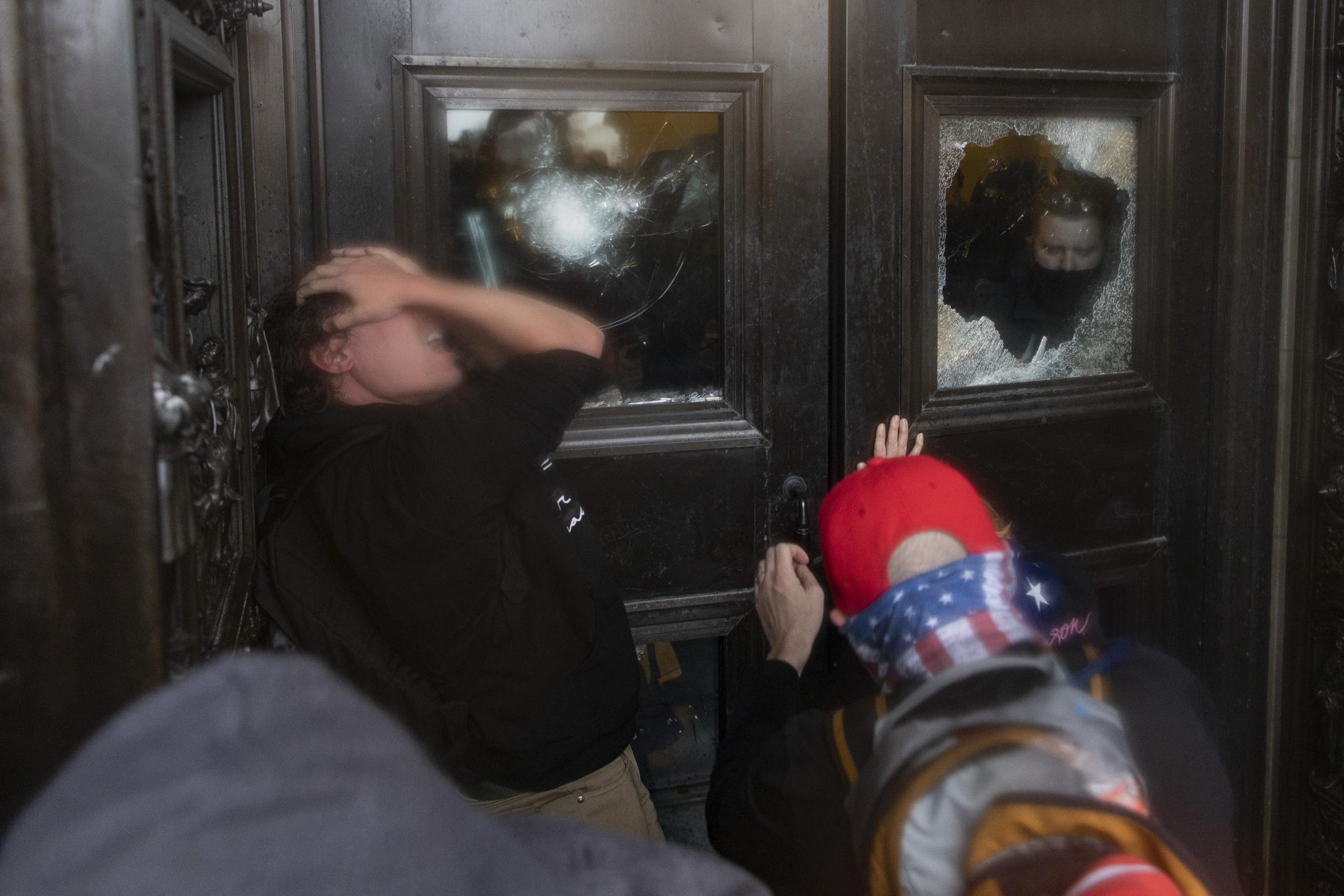 Jan 6 - A protester reacts after being teargased by Capitol...