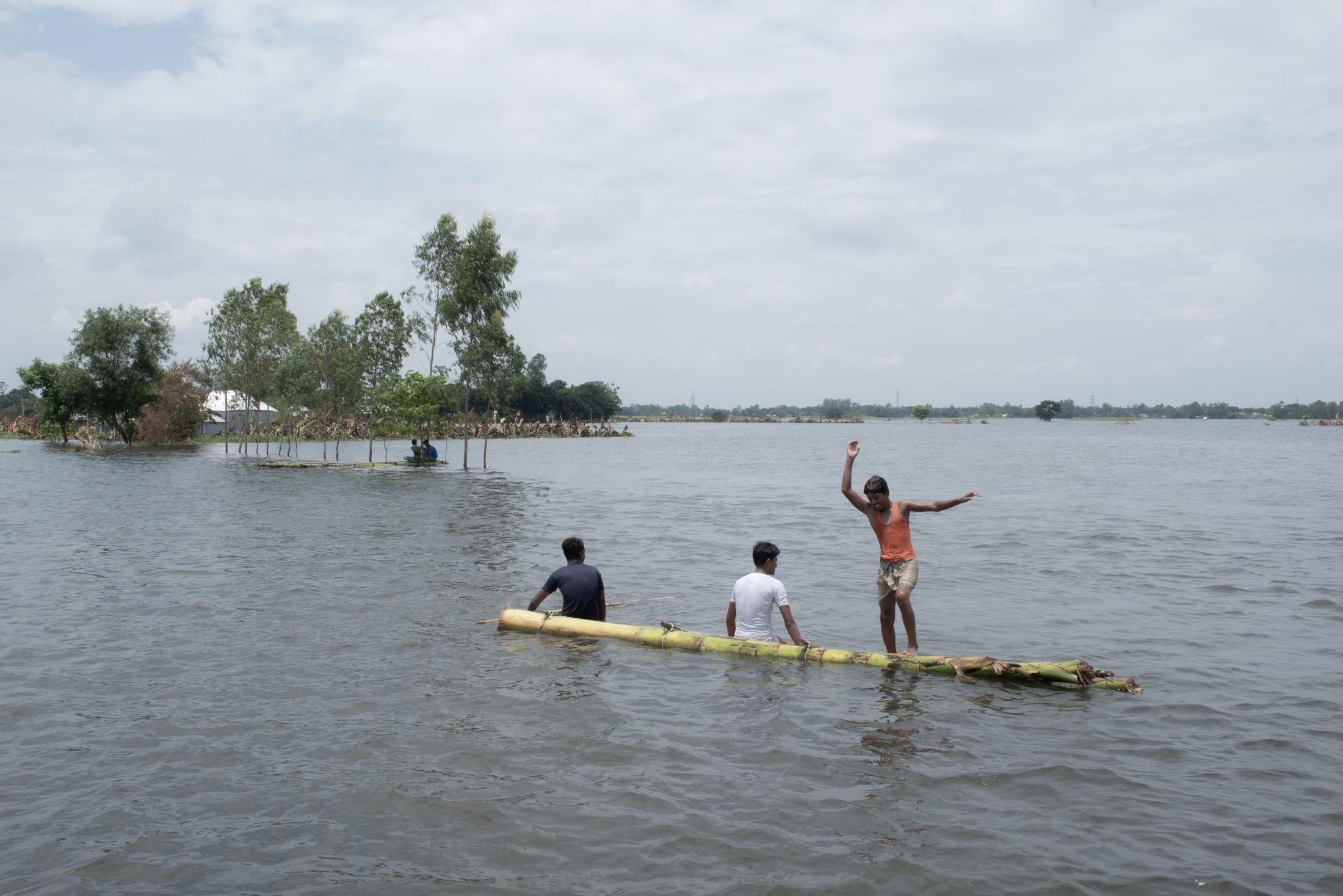 The Depth of Flood - Flood-affected people are seen in a makeshift raft after...