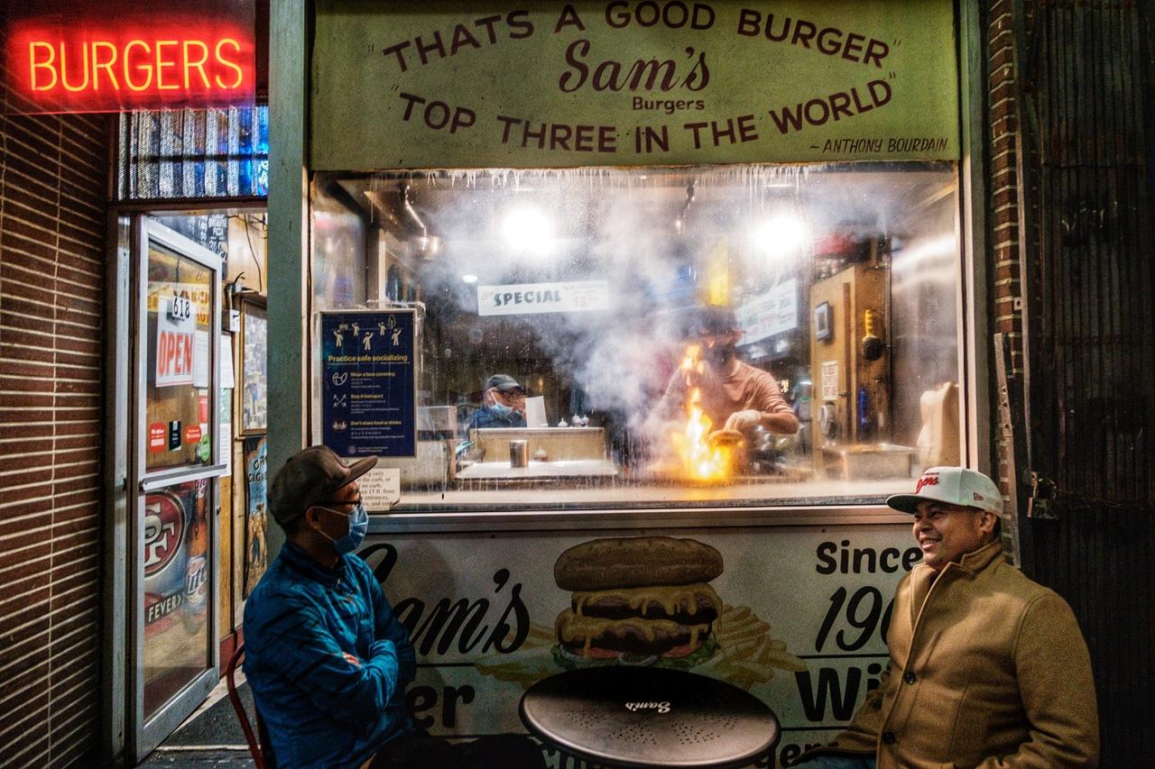 Barry Duong and Richard Aspillera wait for their food outside Sam&rsquo;s Burgers in San Francisco on Saturday, May 22, 2021. Sam&#39;s Burgers is a late night dive that has been a San Francisco institution for more than 50 years and It was recently approved for addition to the Legacy Business Registry.