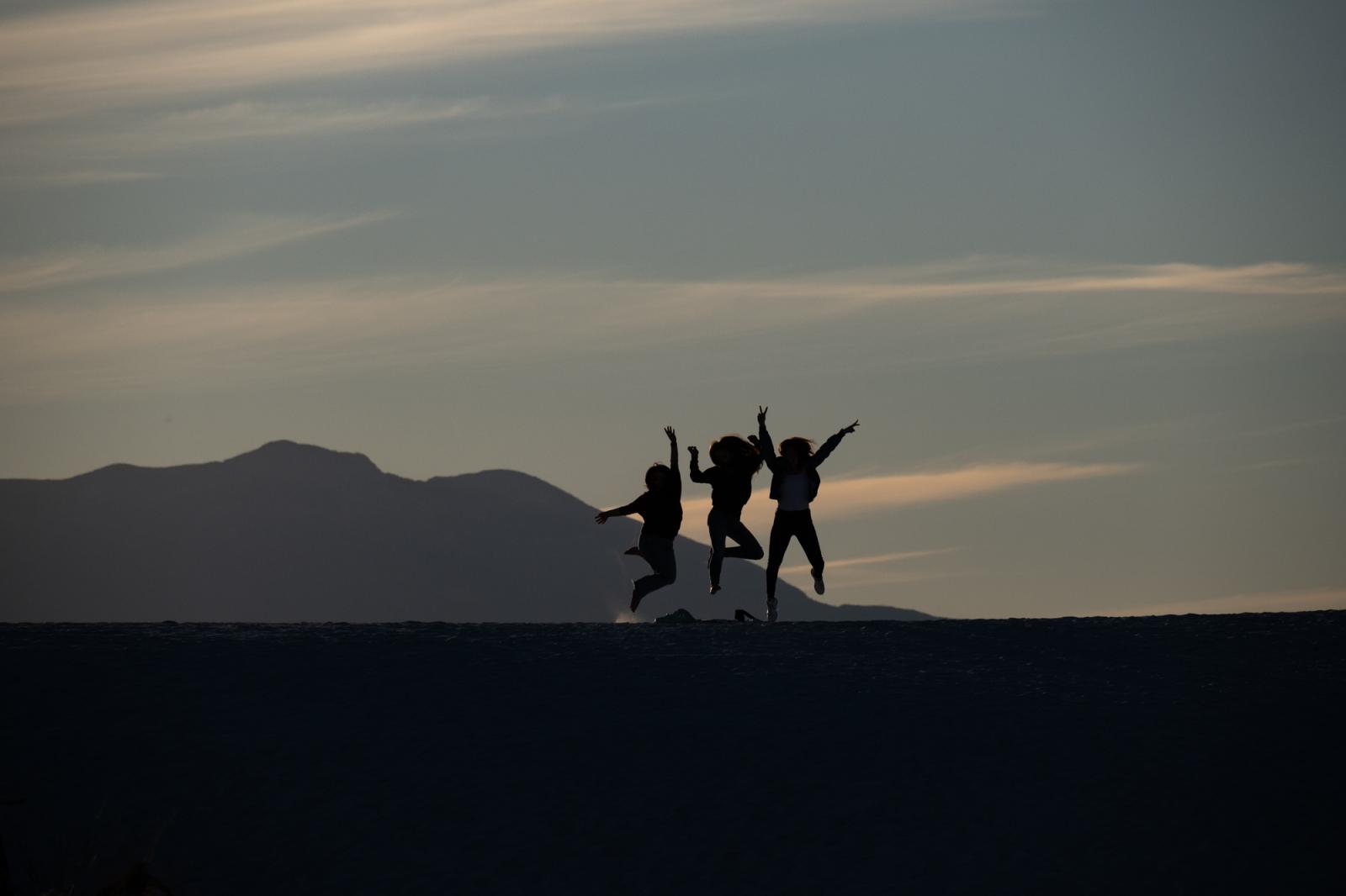People jump for a selfie during... White Sands National Monument.