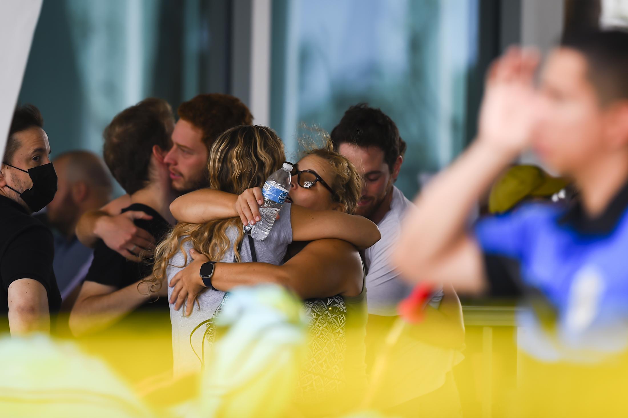 Surfside building collapsed - People hug as they wait for news about relatives at the...