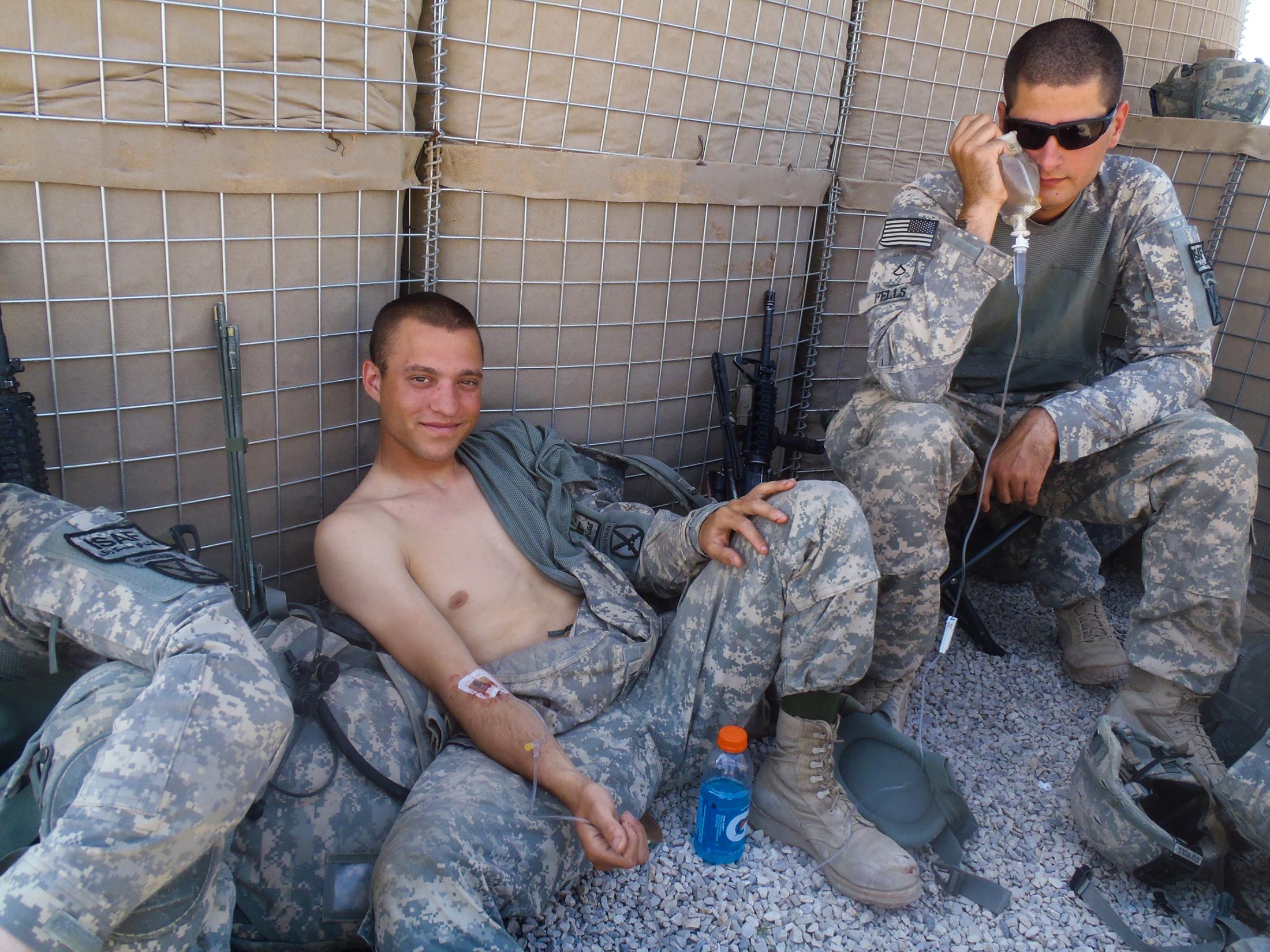 Happy Anniversary from Afghanistan - A soldier receives a saline infusion to combat...