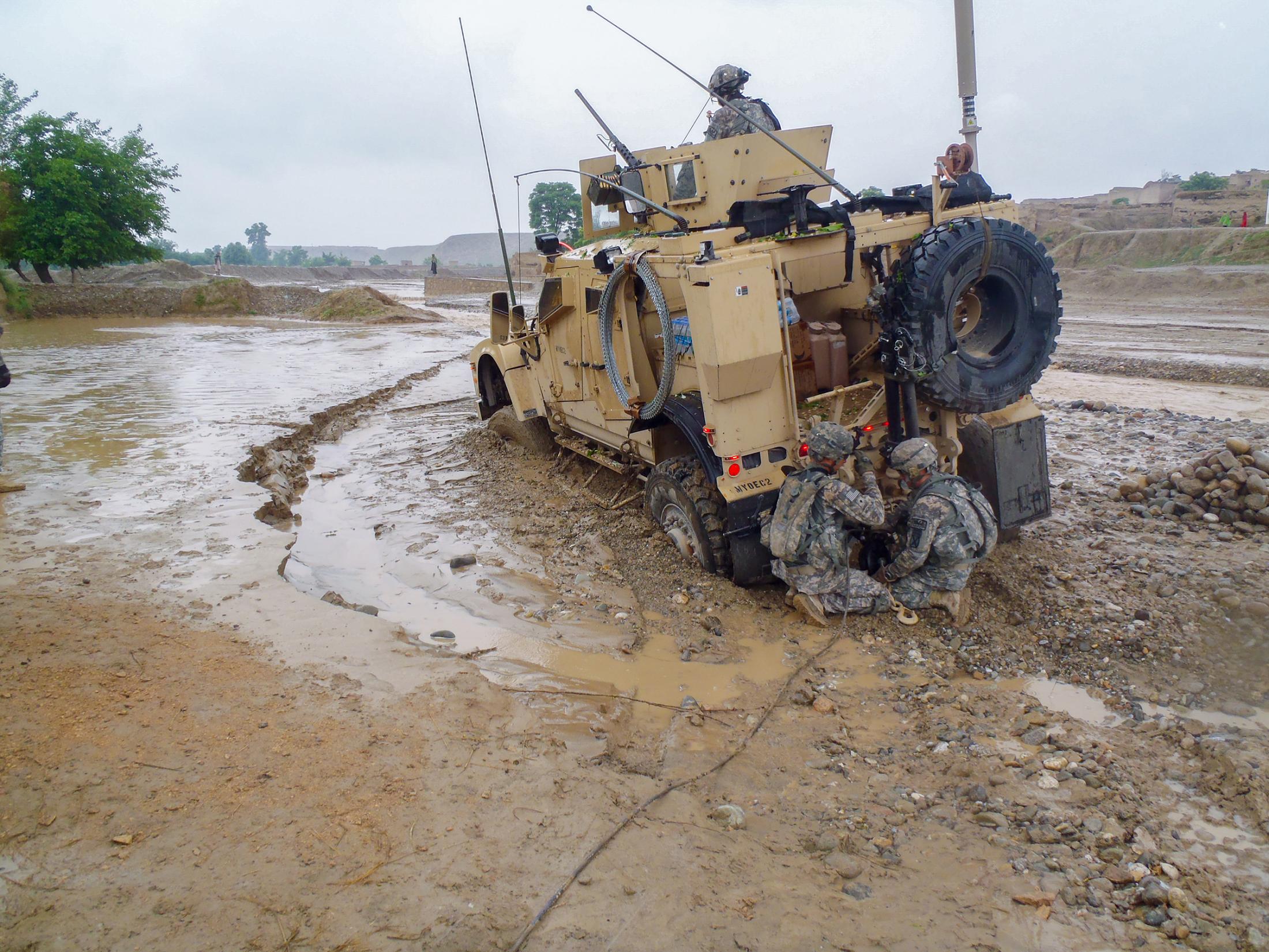 Happy Anniversary from Afghanistan - Soldiers use a winch to get a M-ATV out of the mud during...