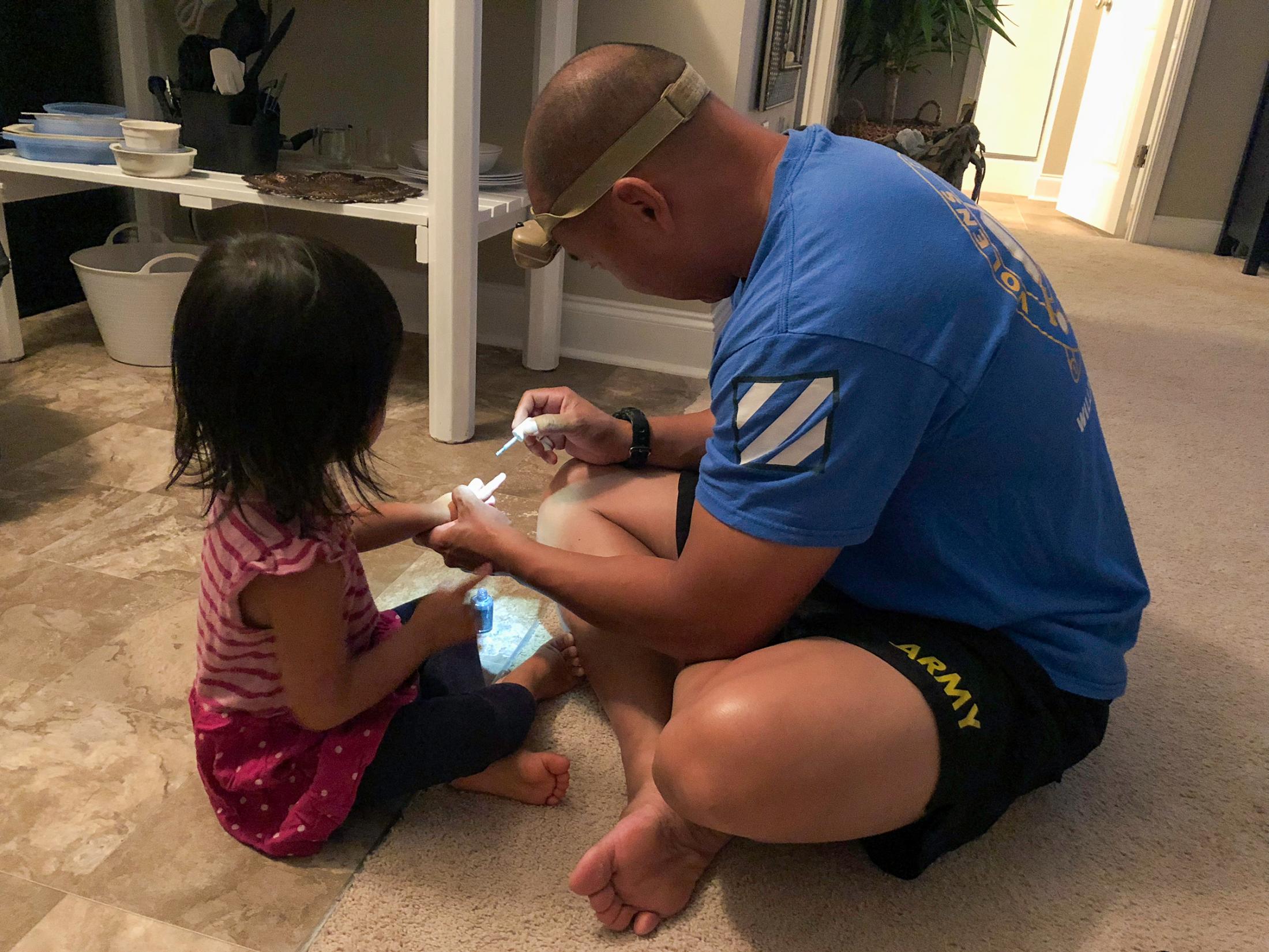 Happy Anniversary from Afghanistan - In Hinesville, Georgia, John paints Mila's nails...
