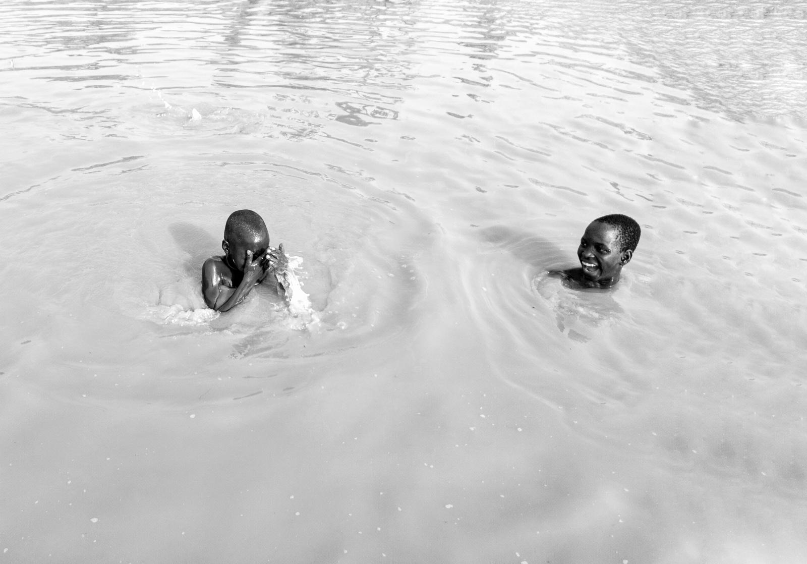05/04/2019 - Two boys have fun ...g swim in a stream in Nasarawa.