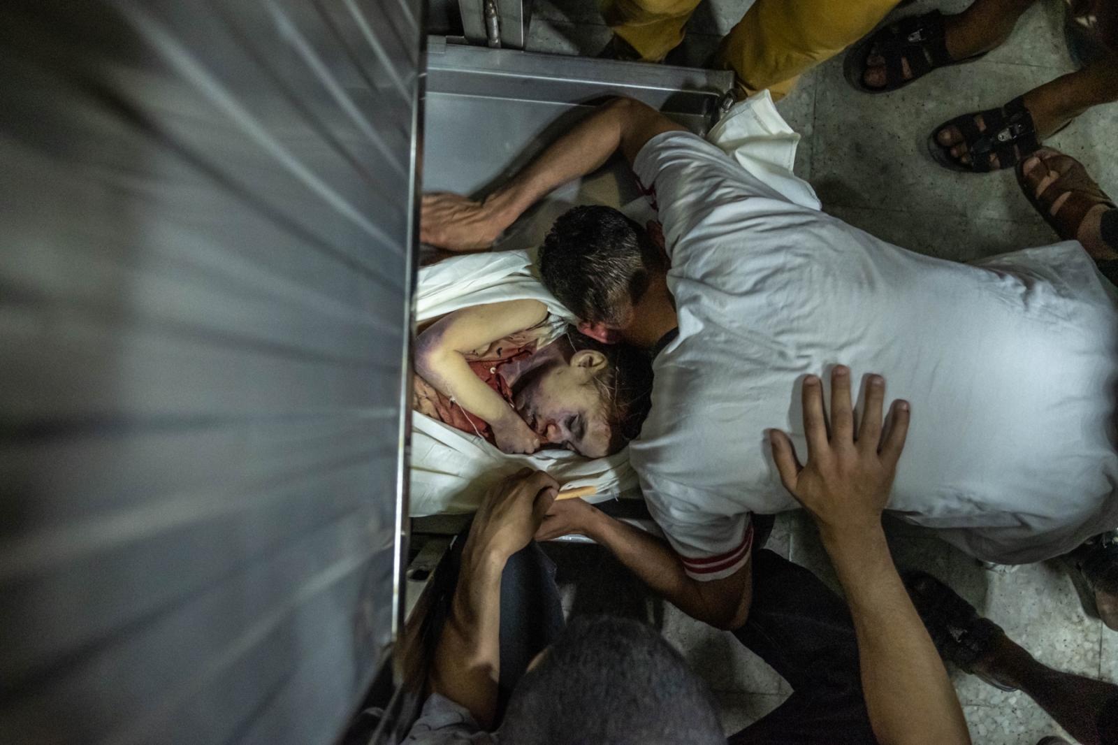 Palestinians inspect bodies of ...ay 16, 2021 in Gaza City, Gaza.
