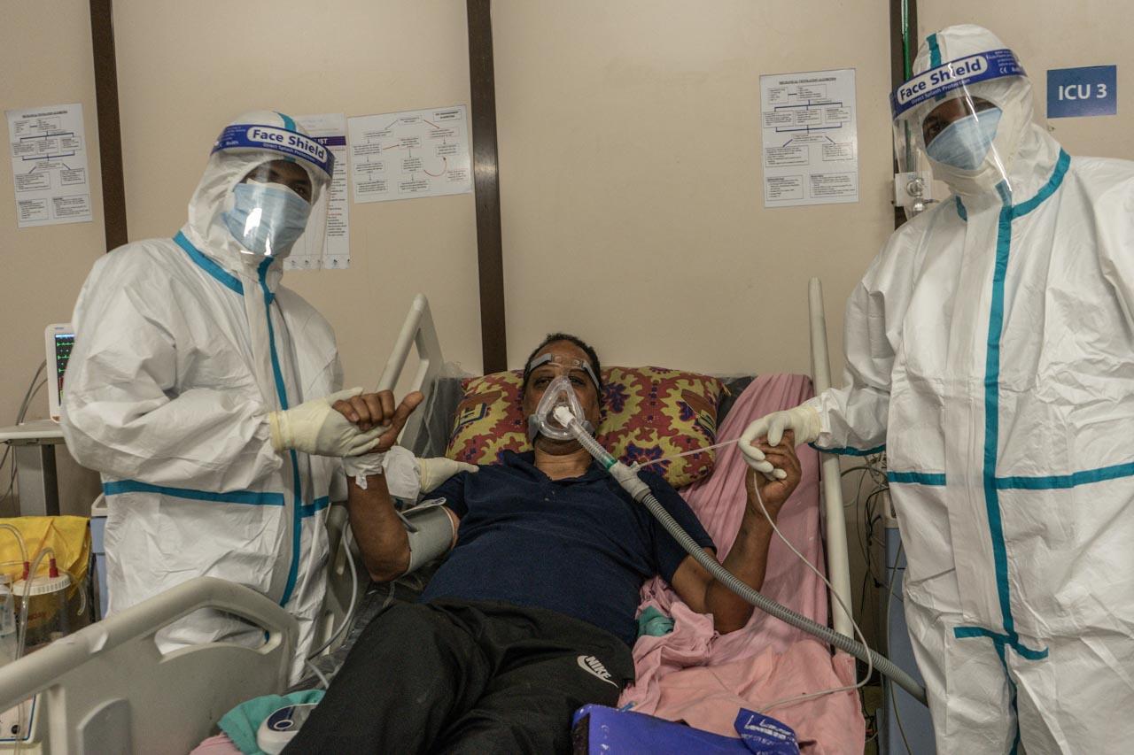  Medical workers pose for a photo with a patient infected with COVID-19 in Addis Ababa, Ethiopia on March 15, 2021 to reassure his family of his health status. 