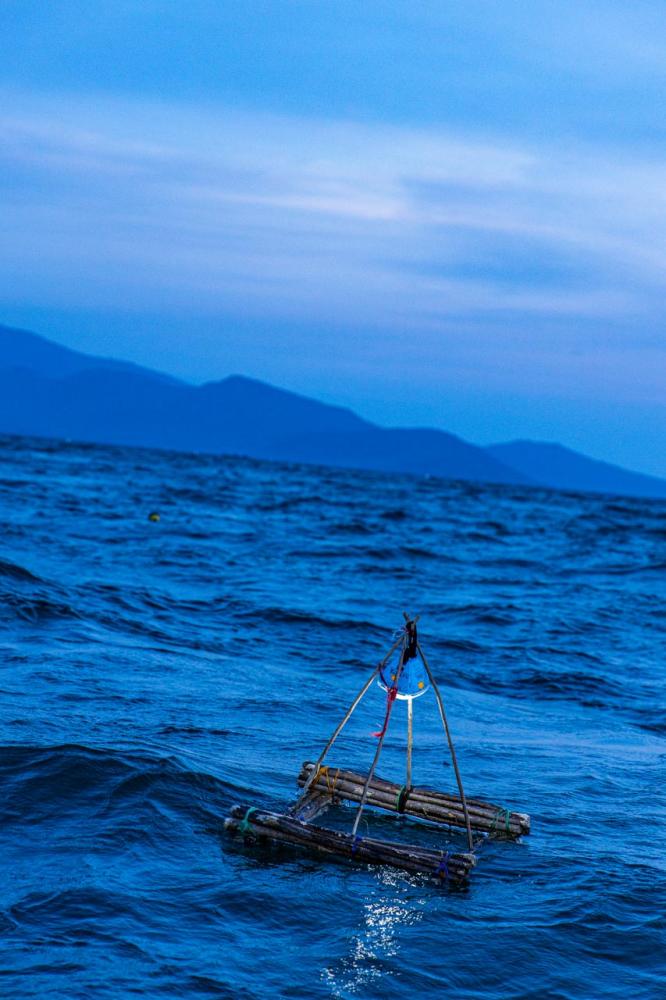 A solar-powered light floating on a fishing stand, Lake Victoria. The solar-powered lamp can be delineated by its white light, as opposed to yellow light, which is produced by kerosene lamps.