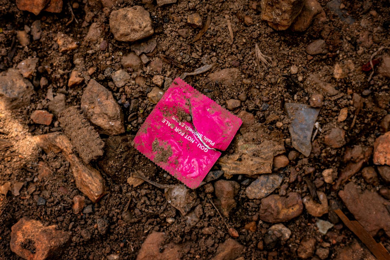 Image from Mukiza Calvin Junior | One in Four  - A condom wrapper on a street in Kalerwe. 