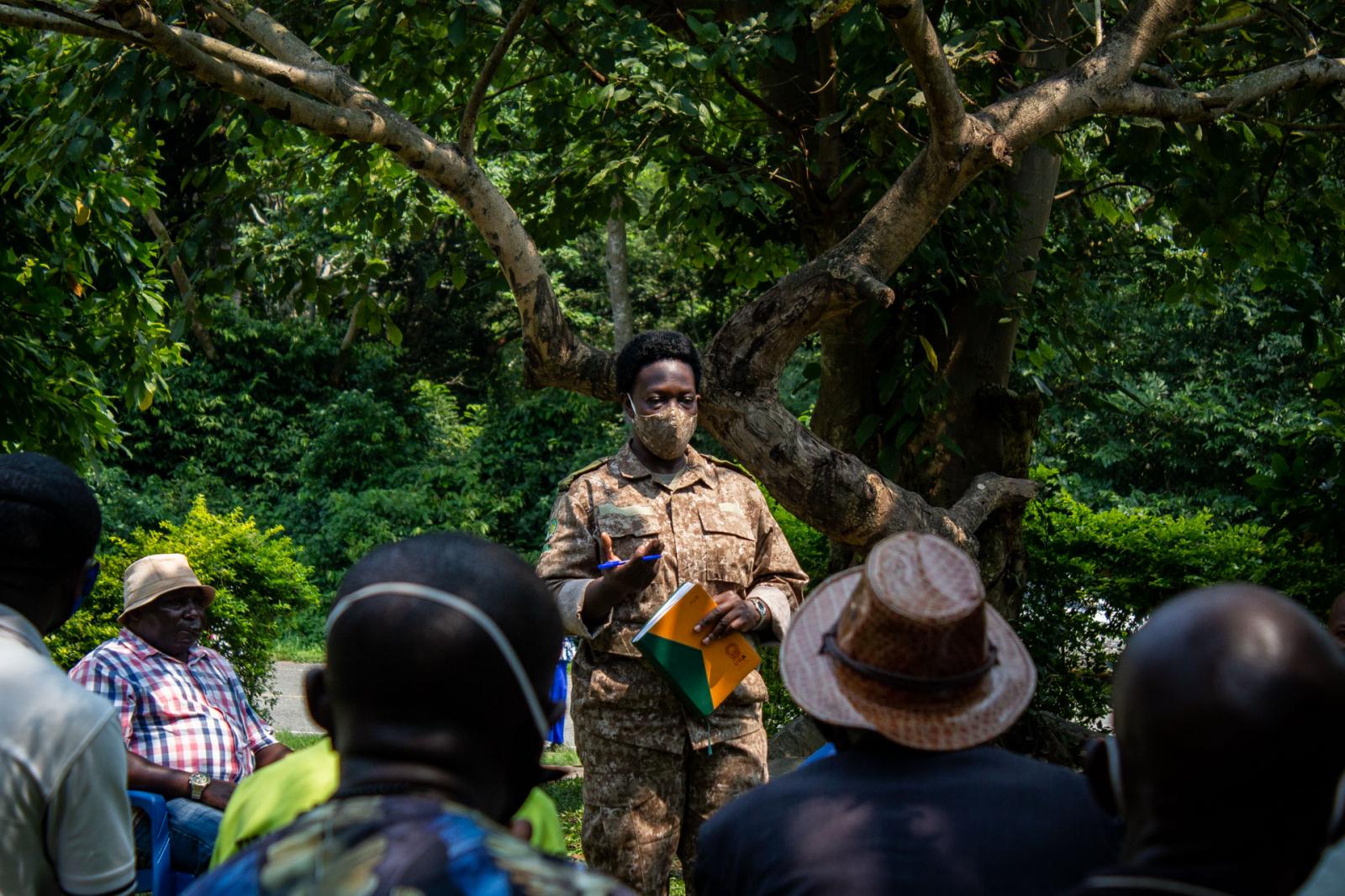Nora Mbubi talks to members of the community about activities taking place in the forest. Community outreach programmes are important as they help people understand the importance of wildlife conservation.