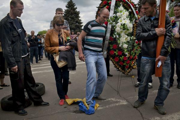 Residents who support Russia stamp on the Ukrainian flag, during the funeral of Yulia Izotova, a 21-year-old nurse who was killed in fighting between pro-Russian protesters and the Ukrainian military, in Kramatorsk, Ukraine.