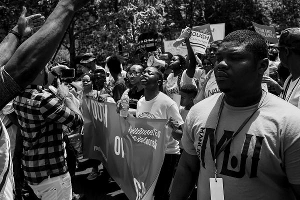 Brother Tivon (R-23) of ManUp Alpha cure violence team, during a peace march over the Brooklyn Bridge. The march marks the beginning of gun violence awareness month (June) in NY.