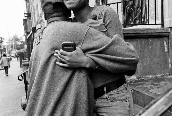 Chris, an S.O.S program participant who found a job, and “got out” of the streets, hugs his girlfriend in the neighbourhood of Crown Heights.