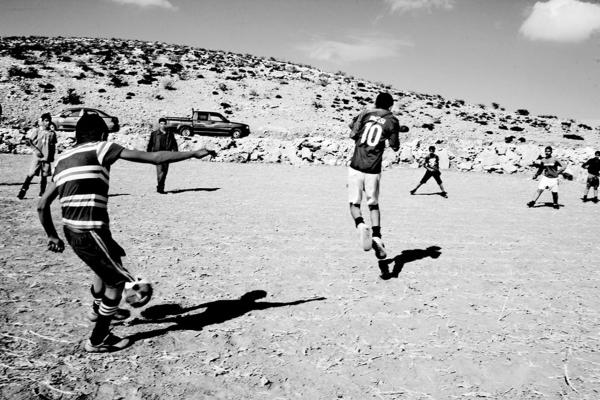 The Land - Bedouin children playing, at the village main football...