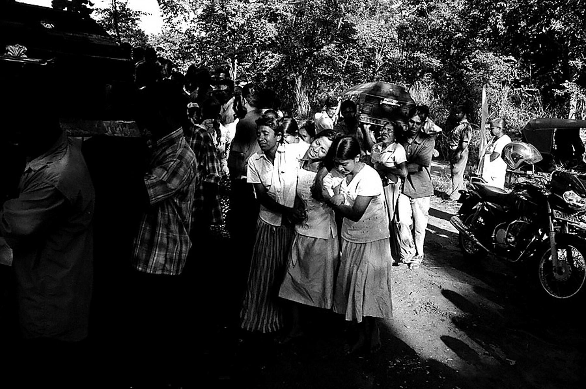 family members of Sinhalese civilians who were killed by a roadside claymore mine explosion made allegedly &nbsp; by LTTE carders , mourn their loved ones death during a mass funeral for 26 people killed in the incident, Buttala, South Sri Lanka