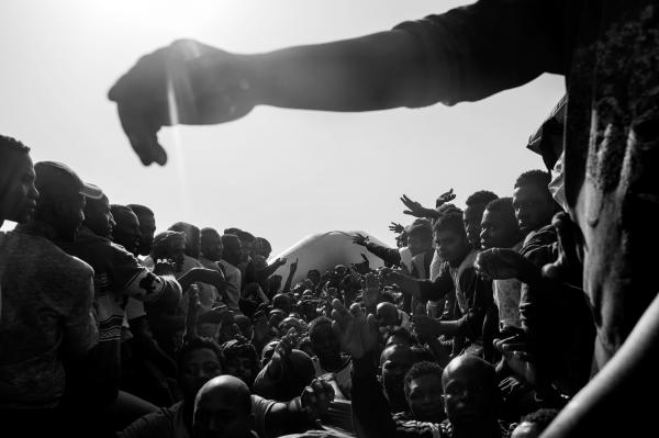 Image from On Strange Waters - A group of around 120 refugees and migrants waiting to...
