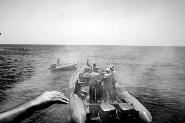 On Strange Waters - A crew Member of Sea Watch waves goodbye to Libyan coast...