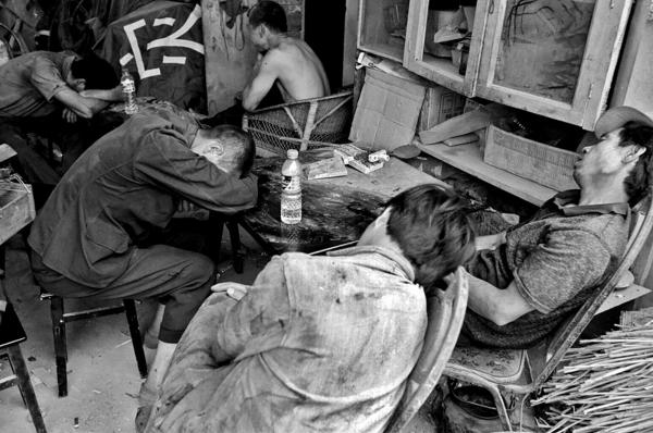 Image from China Quake Aftermath - Quake survivors taking a break from salvaging their...