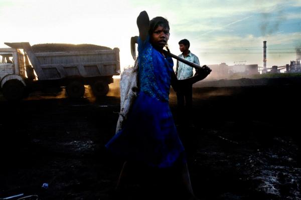 Image from Globalisation - Industrialisation - A young girl from the village of Kalmi, gathering iron...