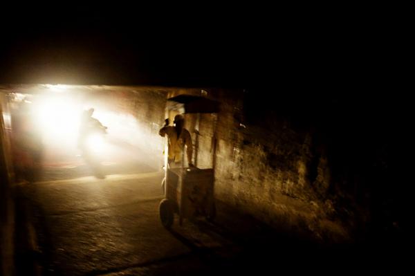 Image from Globalisation - Industrialisation - A man cross an underground bridge with his cart,...