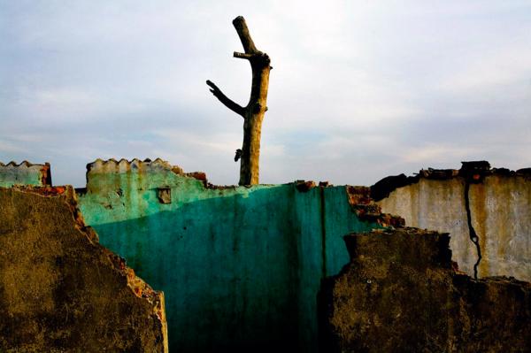Globalisation - Industrialisation - The remains of village houses, at Kumar Baste, a village...