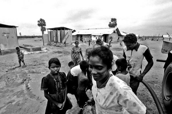 Tamil people collecting water at the IDP camp of Pelachalai, Batticaloa, East Sri Lanka.