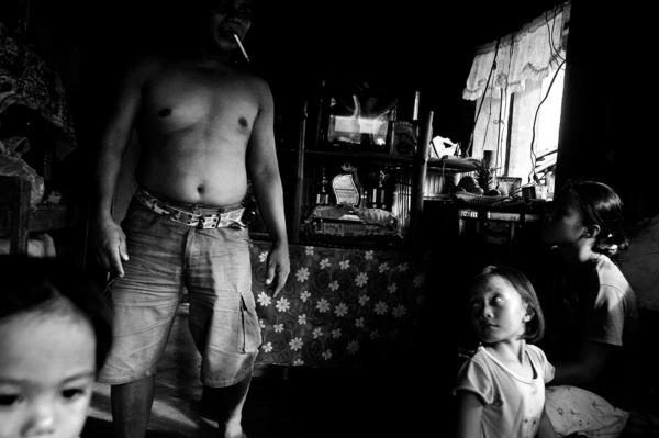 Image from The Ilaga - An illaga member with his children at their home, even...