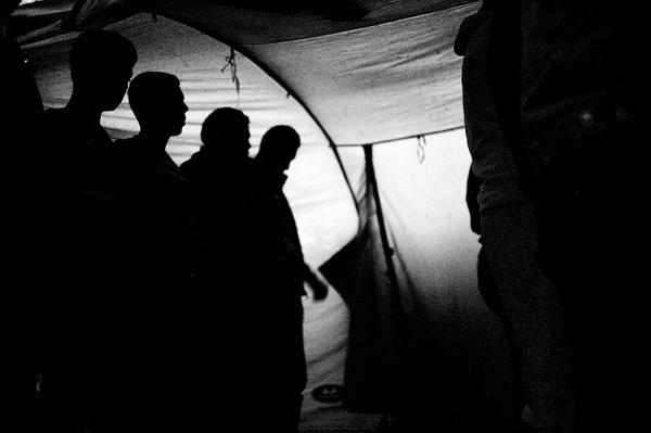 Syrian refugees pray in a tent that was customised as a place of worship, near the tents they live in, in the camp.