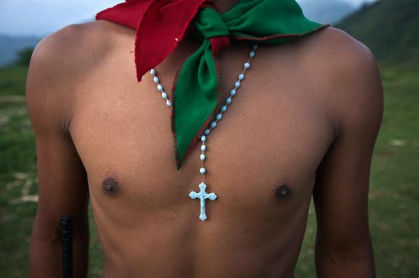 A young member of the Nasa guard wearing the guard scarf and a crucifix &nbsp;. Miranda, North Cauca.