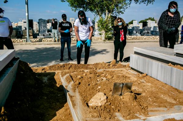 Family members of Yaffa Nagar (age 90) mourning during her funeral. she passed away from Covid-19. Beer-Sheva cemetery, Israel.