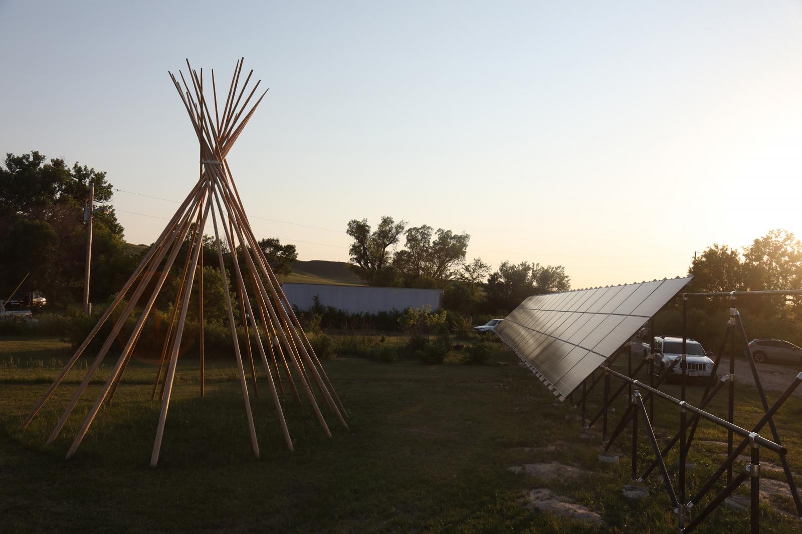 A teepee is reflected onto solar panel on the Pine Ridge reservation in South Dakota, June 16, 2021.