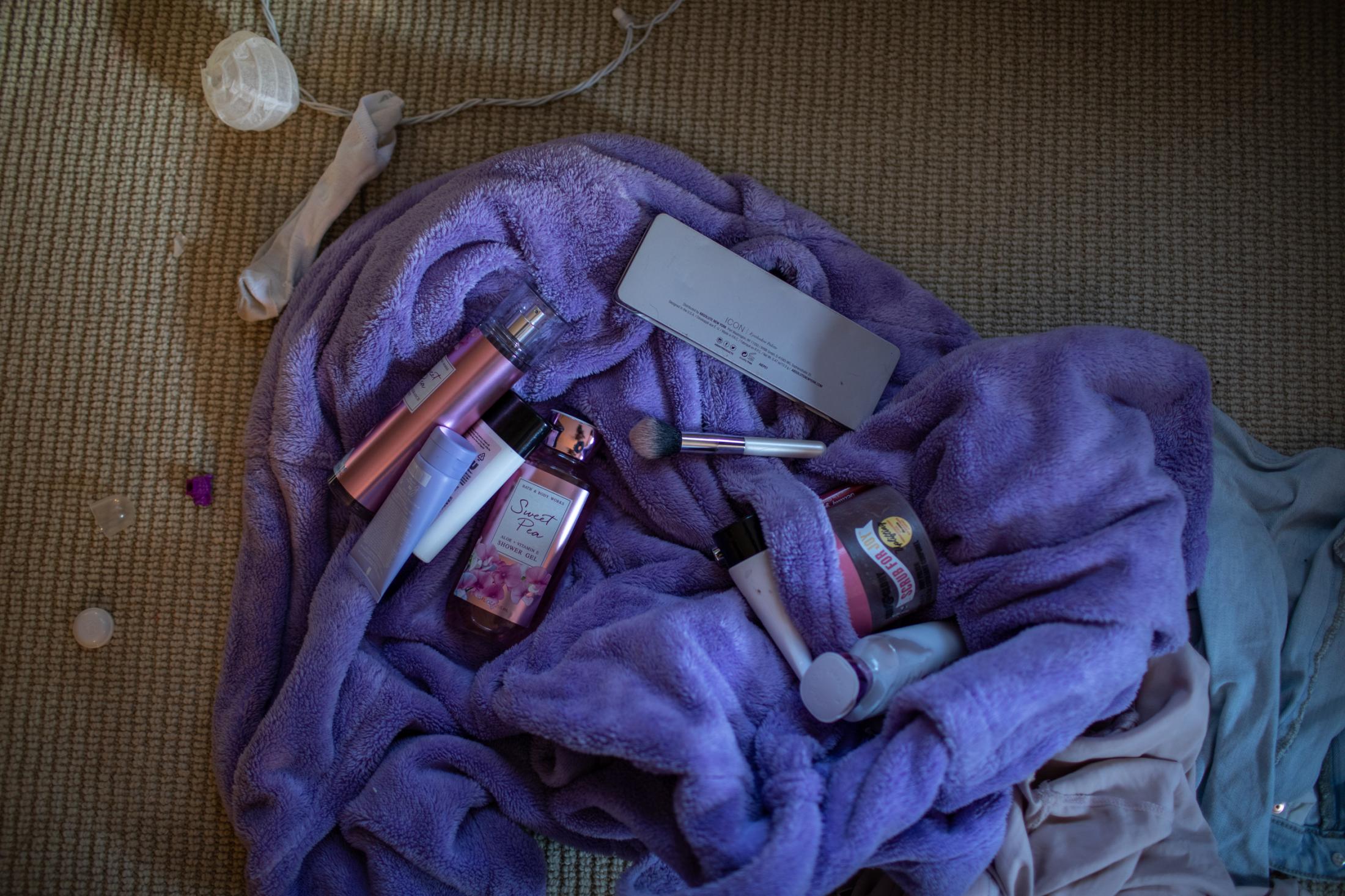 Jaylan Cosmetic products lay on the carpet, South Portland, Maine, September, 2021.