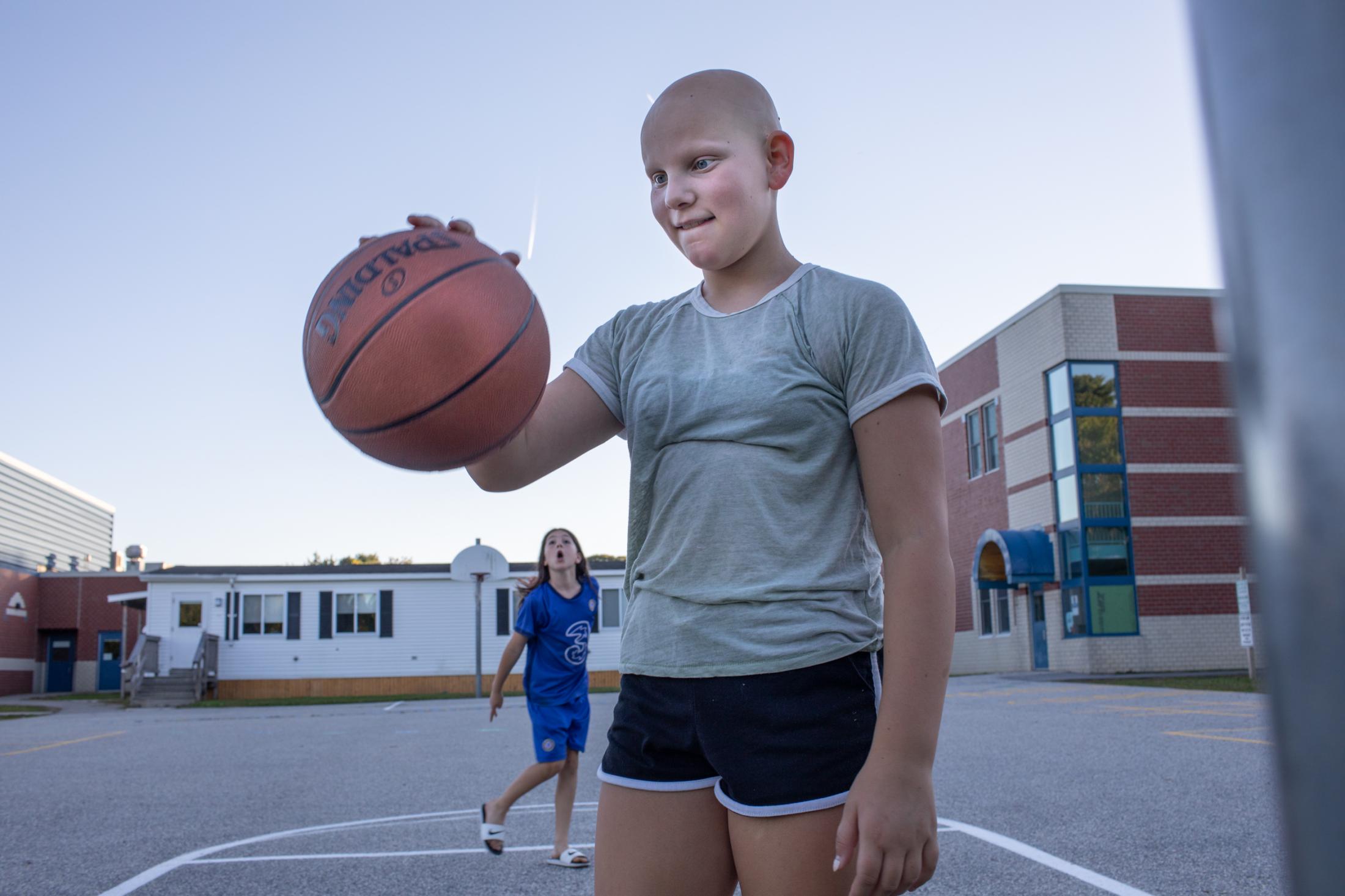 Violet and Jaylan play basketball and the elementary school next to their house, South Portland,...