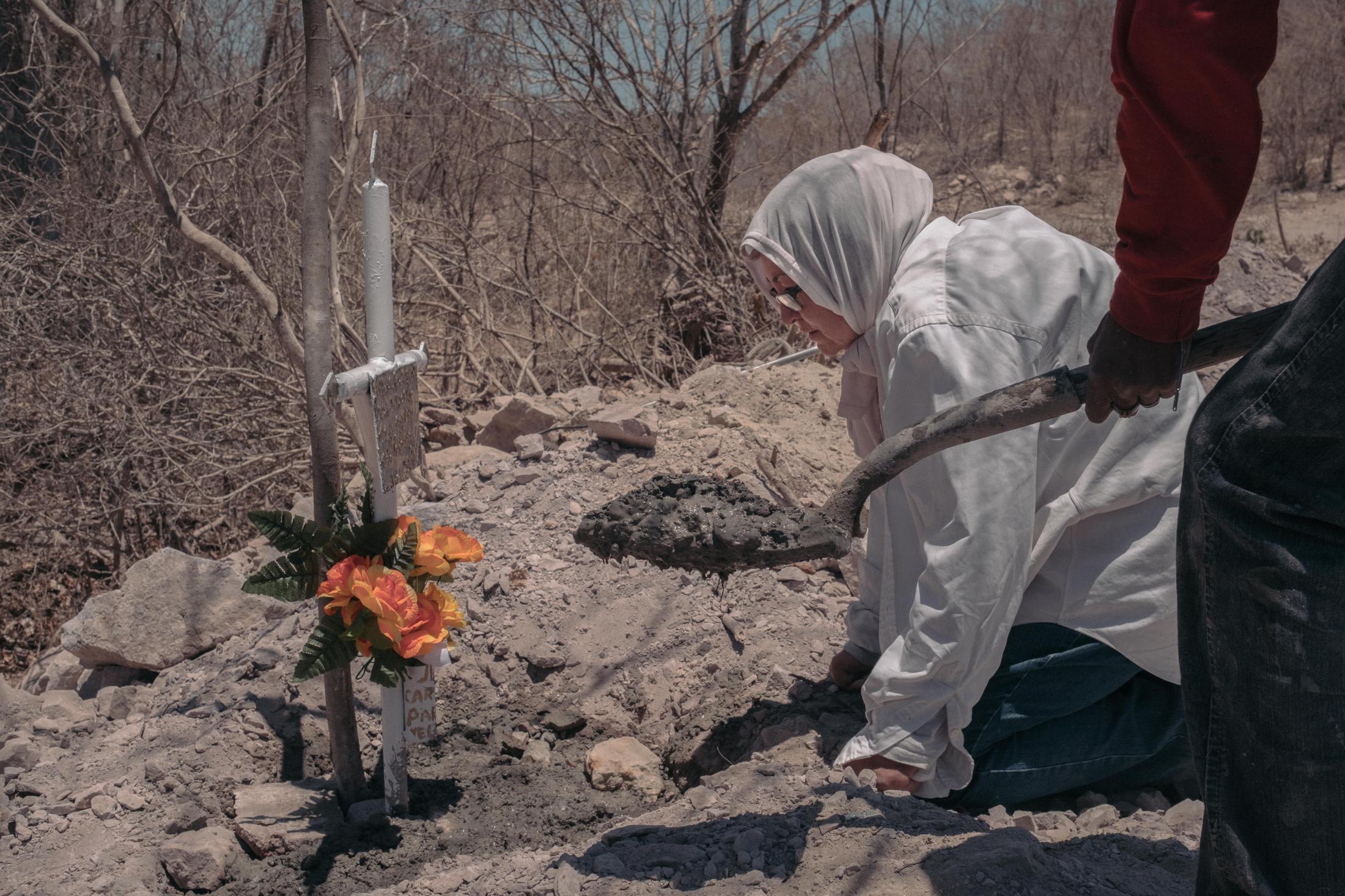 Lost Treasures -  Consuelo Velarde buries a cross where she has just found...