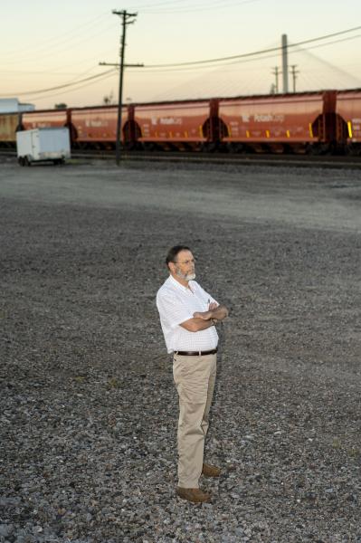 Portraits - Dale Alison stands near the railyard behind the office of...