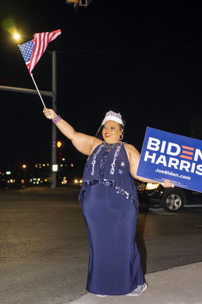 Image from Politics - Melanie Weatherall waves a flag and holds a sign in...