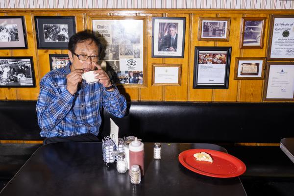 Image from Portraits - Hamburg Inn owner Michael Lee eats egg drop soup prepared...