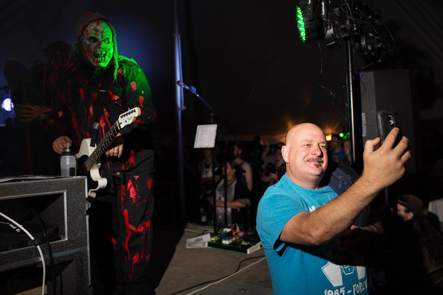 A fan takes a selfie with Christian metal band Grave Robber at Audiofeed Festival in Urbana,...