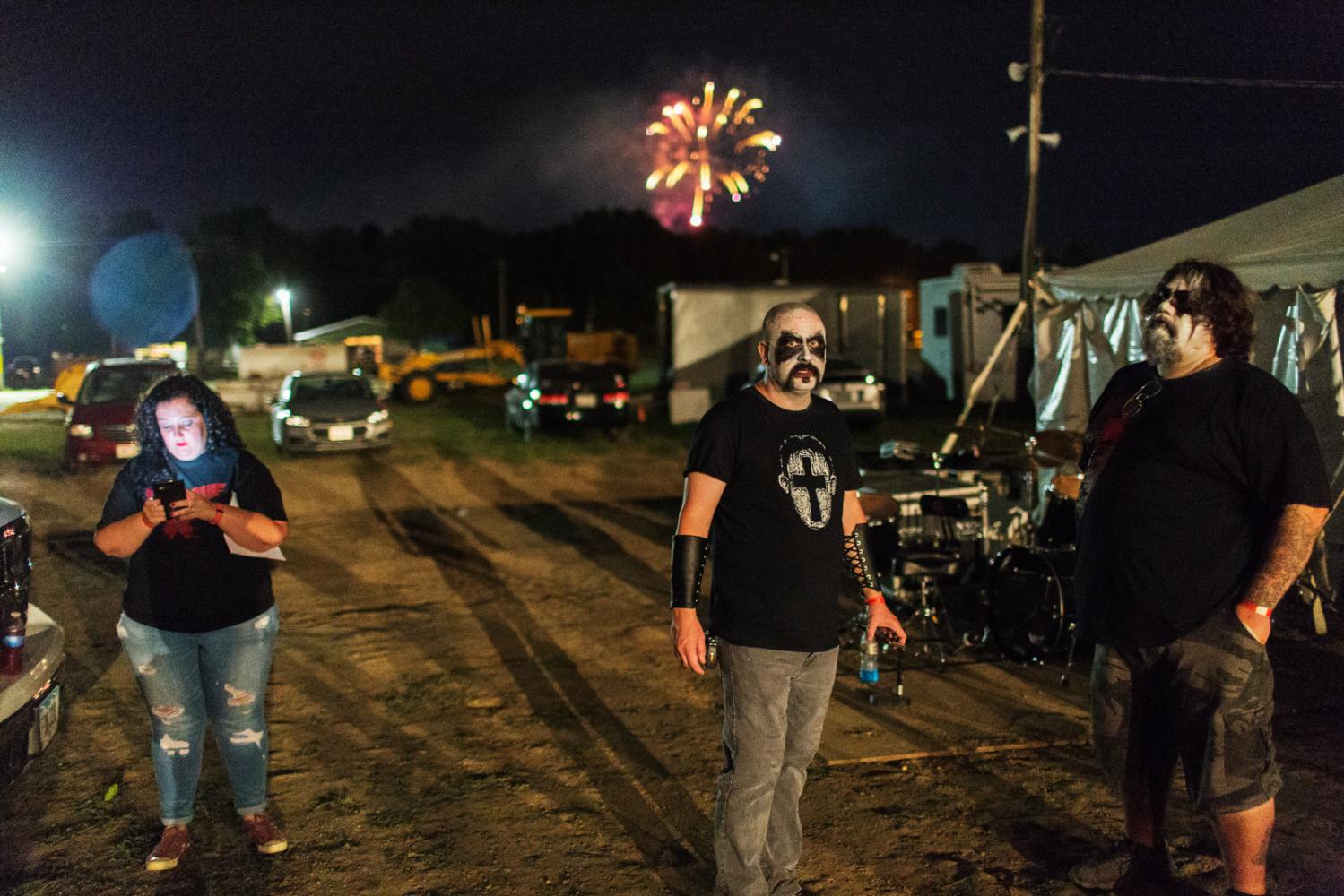 A band gets ready to perform while fireworks go off in the background at Audiofeed Festival in...
