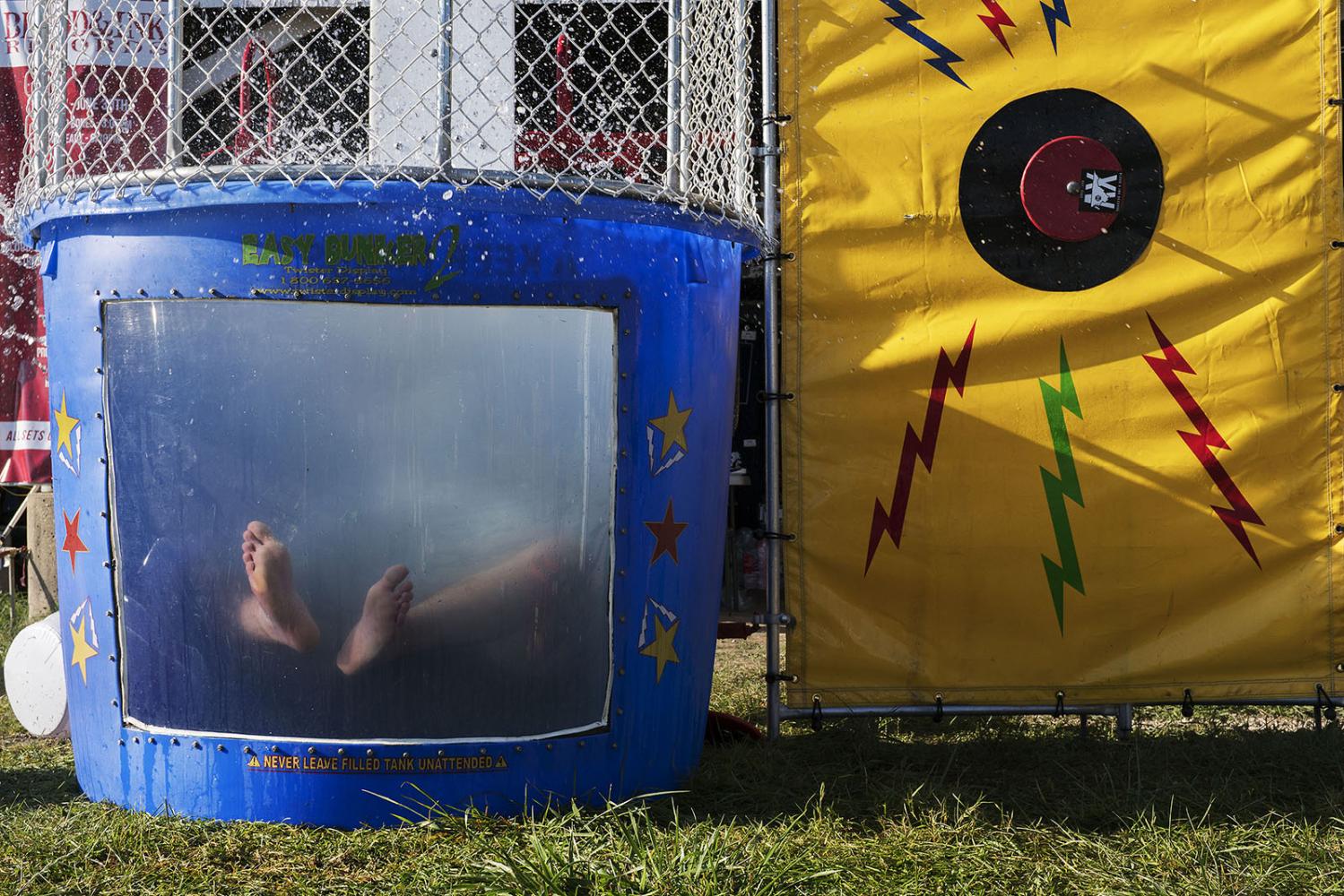 A member of the Blood &amp; Ink label gets dunked in a dunk tank at Audiofeed Festival in...