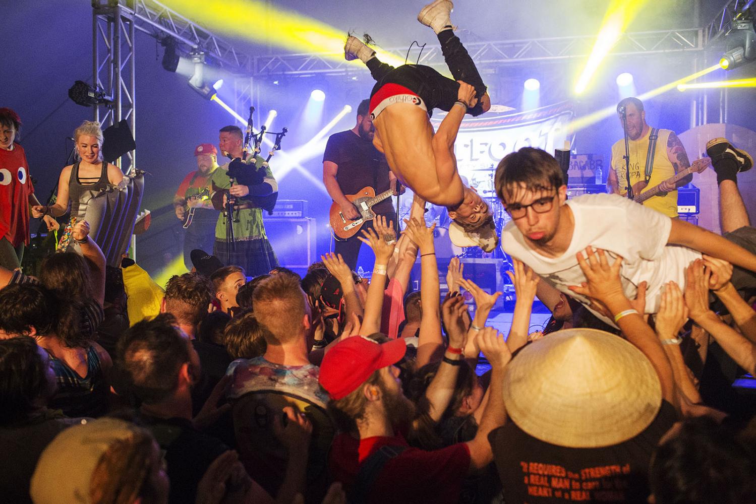 Fans crowd surf to Irish punk band Flatfoot 56 at Audiofeed Festival in Urbana, Illinois on...