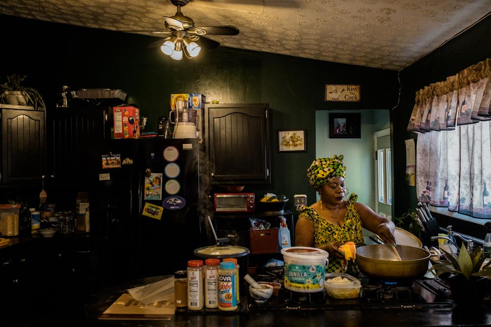 PIKESVILLE, MD - OCTOBER 28, 2021: Tryphena Teah, 49, makes chuck rice and gravy in her home in Pikesville, Maryland on October 28, 2021. Chuck rice and gravy are some of the commonly made dishes for Liberian Thanksgiving. &ldquo;For us Liberians, cooking is fun for us because it is another way of teaching our kids our culture and ways to take care of the household,&rdquo; says Teah. &ldquo;For Thanksgiving, we cook early in the morning or the night before. Then, we all go to church to give thanks and then we all come together.&rdquo; (Photo by Rosem Morton for The New York Times)