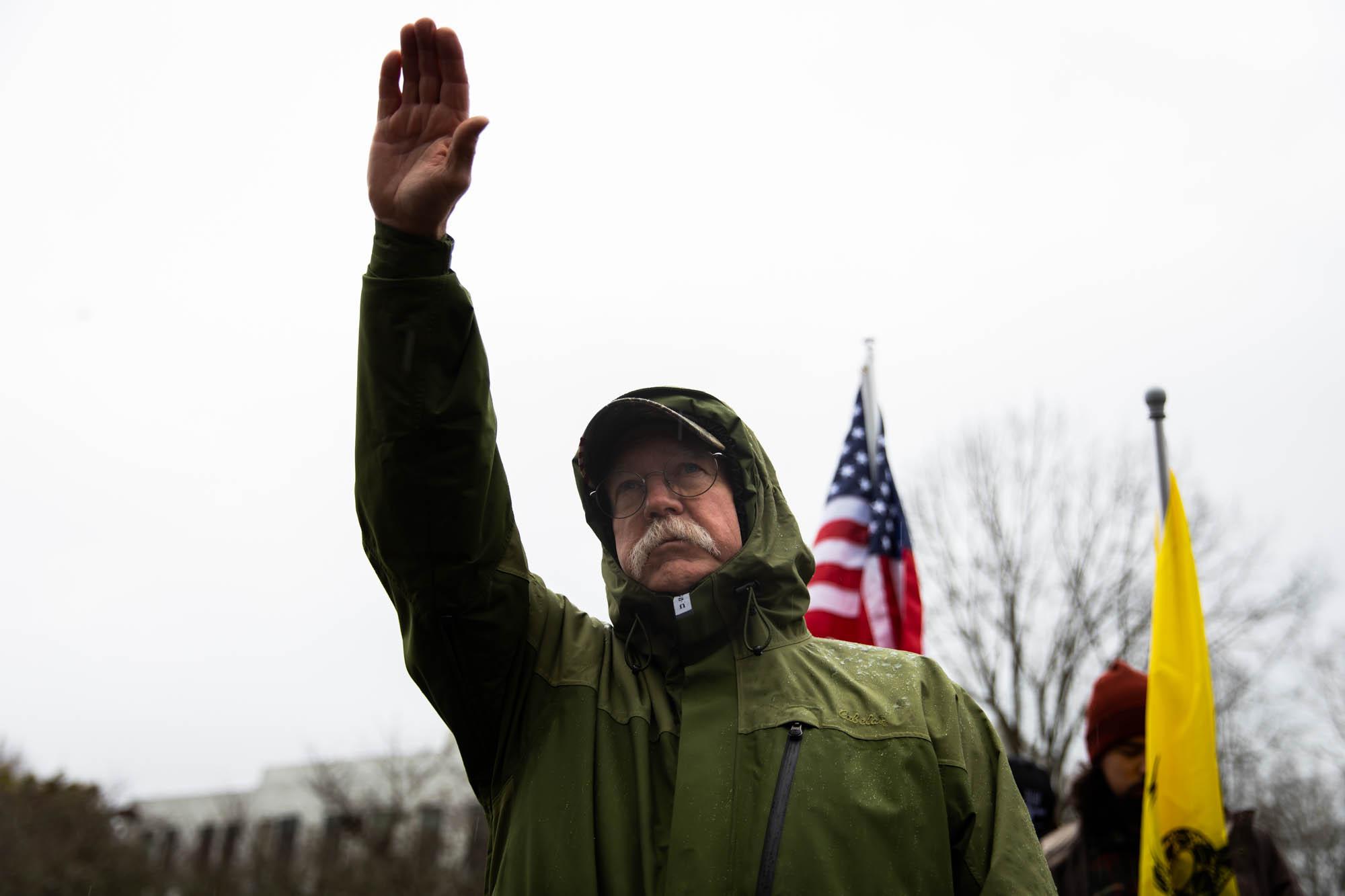 American Patriot - A man raises his arm in a Nazi salute during a far-right...